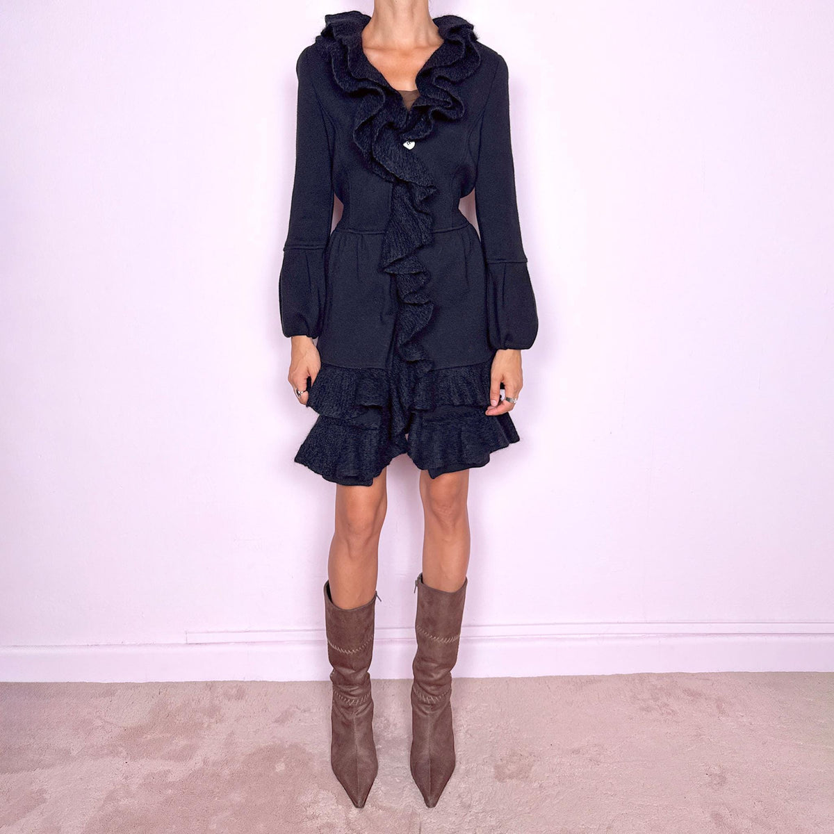 Vintage 2000s black wool coat, crafted from 100% wool with contrasting textured inserts in a blend of 50% mohair, 30% polyamide, and 20% wool. Featuring a fitted silhouette with dramatic ruffled trim through the neckline and front, voluminous sleeves, button closure, and pockets. Finished with a removable fabric belt that can be tied at the front or back to adjust the shape. From an Italian brand. Great vintage condition.