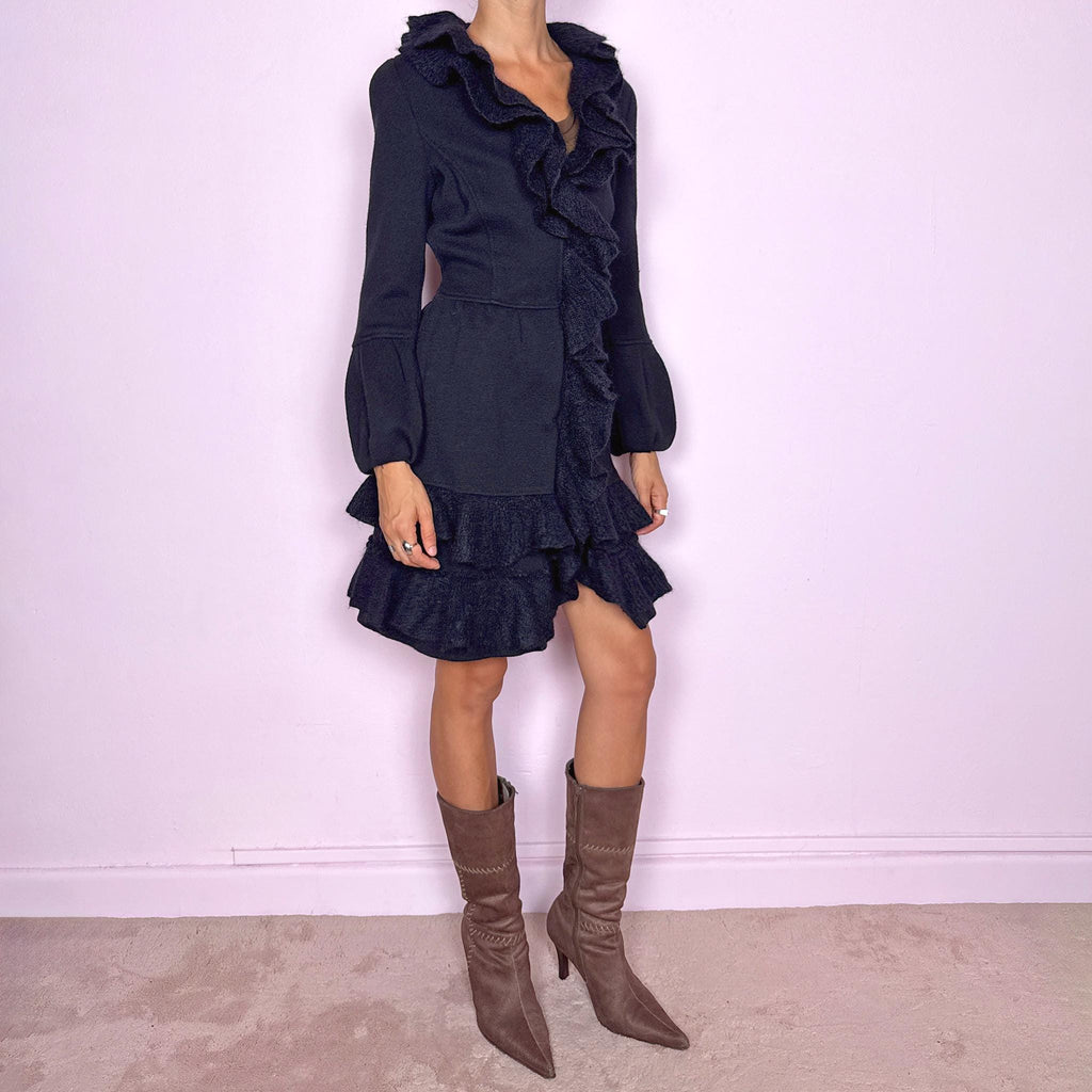Vintage 2000s black wool coat, crafted from 100% wool with contrasting textured inserts in a blend of 50% mohair, 30% polyamide, and 20% wool. Featuring a fitted silhouette with dramatic ruffled trim through the neckline and front, voluminous sleeves, button closure, and pockets. Finished with a removable fabric belt that can be tied at the front or back to adjust the shape. From an Italian brand. Great vintage condition.