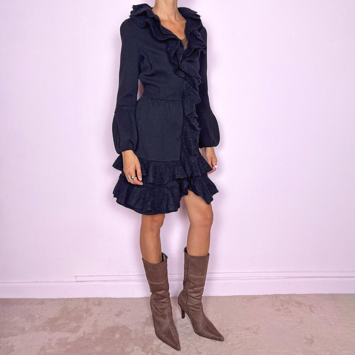 Vintage 2000s black wool coat, crafted from 100% wool with contrasting textured inserts in a blend of 50% mohair, 30% polyamide, and 20% wool. Featuring a fitted silhouette with dramatic ruffled trim through the neckline and front, voluminous sleeves, button closure, and pockets. Finished with a removable fabric belt that can be tied at the front or back to adjust the shape. From an Italian brand. Great vintage condition.