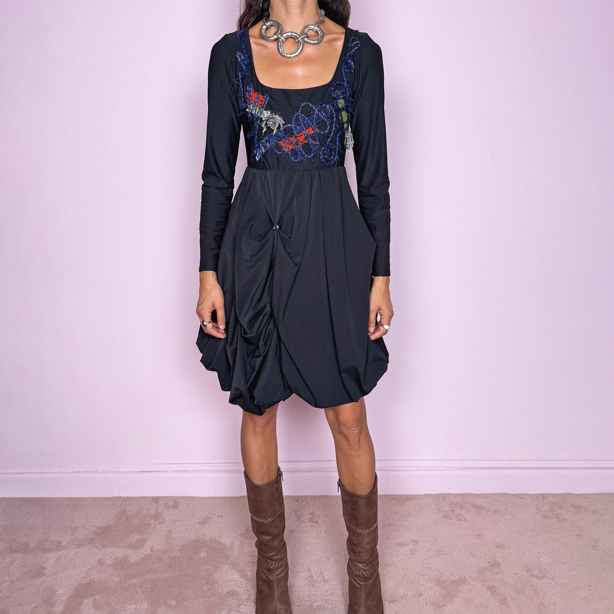 Vintage 2000s black long-sleeve mini dress by Italian label Save the Queen, made in Italy. Featuring a fitted stretchy bodice with a scoop neckline, layered textile appliqué detailing across the chest, and a sculptural draped bubble skirt with gathered volume and asymmetric folds. The sleek bodice and exaggerated balloon silhouette create an avant-garde, deconstructed look. Composition label is missing, so the exact fabric is unknown. Excellent vintage condition.