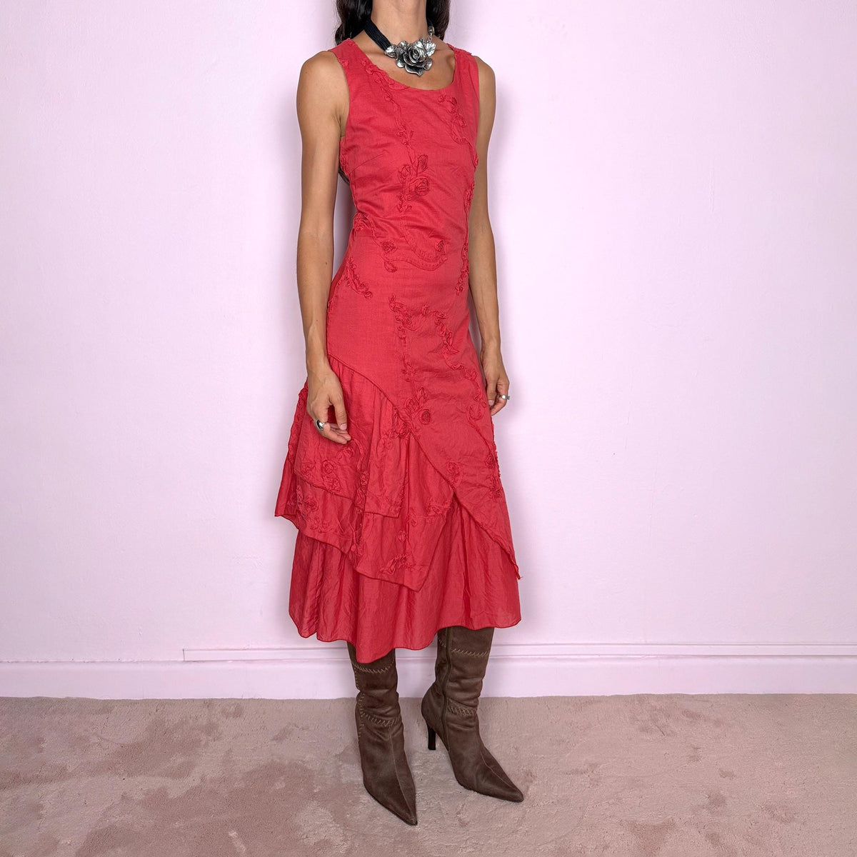 Vintage 2000s muted red midi dress featuring a fitted sleeveless bodice, subtle floral embroidery throughout, layered asymmetric paneling, and a softly flared tiered hem. Finished with a back zip closure. Non-stretch. The slightly faded brick-red tone, textured embroidery, and irregular layered construction give it a rustic, deconstructed aesthetic. Made in France from 100% cotton with a 100% polyester lining, from a French brand. Great vintage condition.