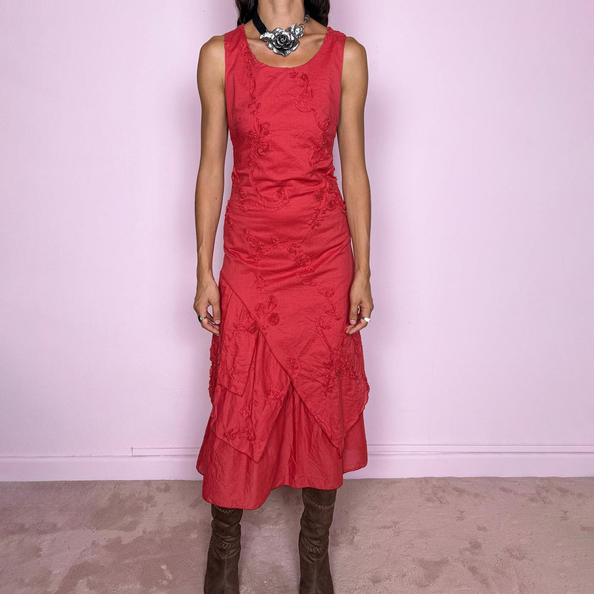 Vintage 2000s muted red midi dress featuring a fitted sleeveless bodice, subtle floral embroidery throughout, layered asymmetric paneling, and a softly flared tiered hem. Finished with a back zip closure. Non-stretch. The slightly faded brick-red tone, textured embroidery, and irregular layered construction give it a rustic, deconstructed aesthetic. Made in France from 100% cotton with a 100% polyester lining, from a French brand. Great vintage condition.