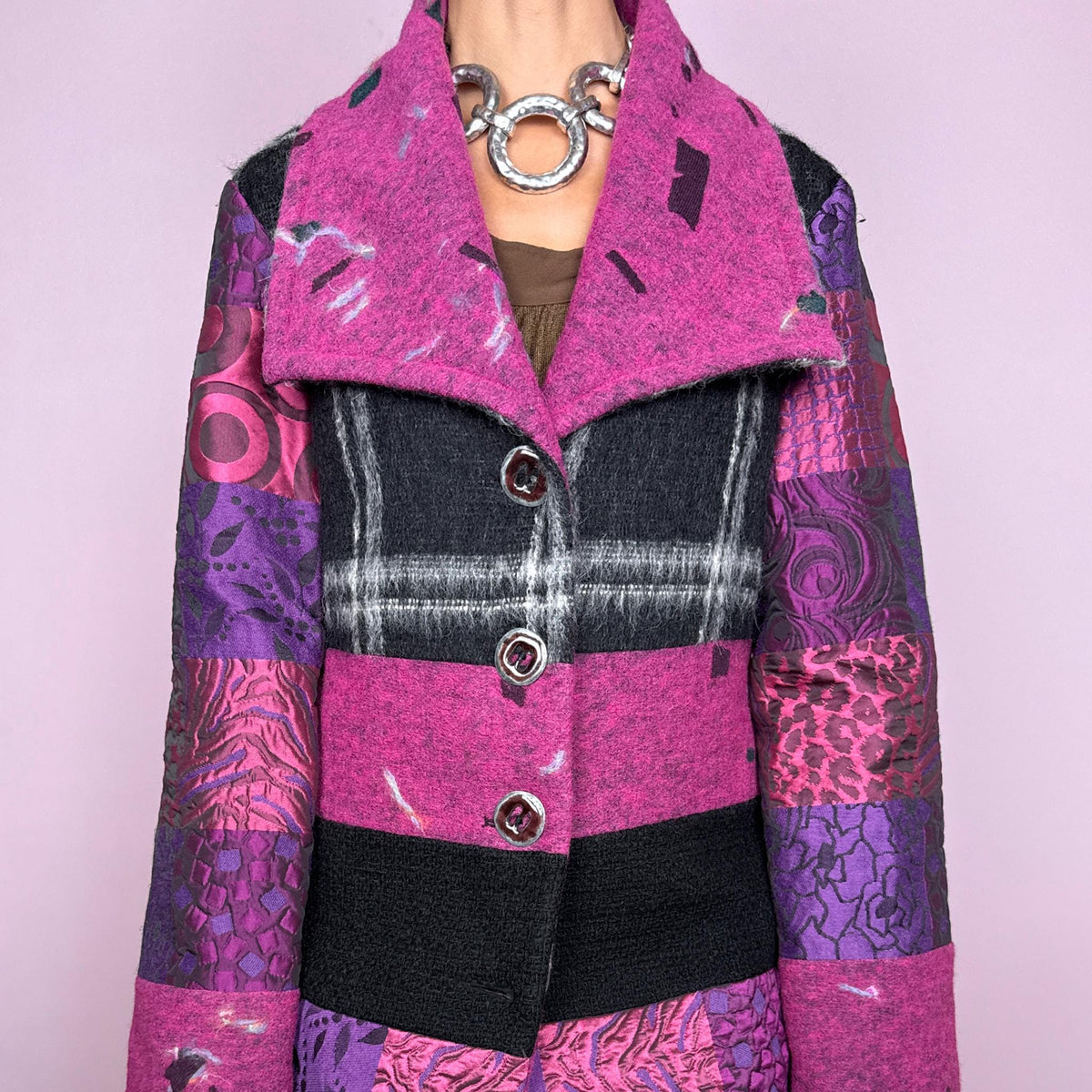 Vintage 2000s colorful wool-blend jacket by Italian label Save the Queen, made in Italy from 60% wool and 40% polyester. Features a fitted, tailored silhouette with an oversized magenta collar, statement button-front closure, and a bold patchwork-inspired mix of black, fuchsia, and purple panels with abstract, animal, and graphic motifs. Perfect for playful avant-garde maximalist styling, statement winter looks, and colorful outfits. Excellent vintage condition.
