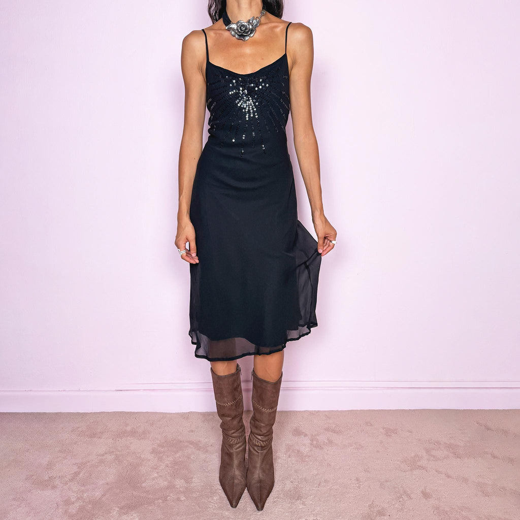Vintage 2000s black silk midi dress crafted from 100% silk. Featuring a fluid slip-style silhouette with adjustable spaghetti straps and black sequin embellishment across the bust. Lightweight and non-stretch, with a semi-sheer outer layer and black lining underneath. Perfect for minimal evening styling. Excellent vintage condition.
