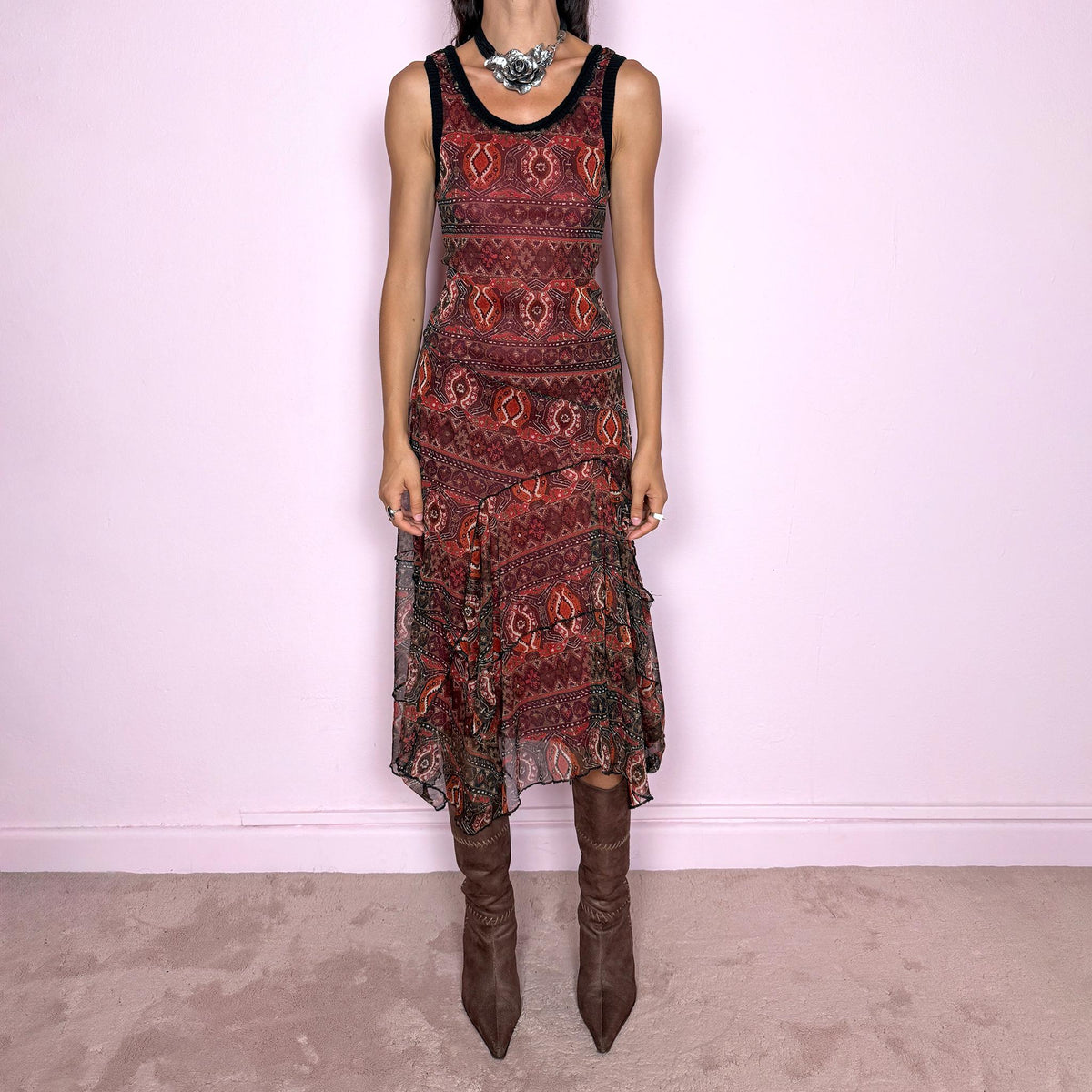 Vintage 2000s printed mesh two-piece dress set. The set includes a fitted sleeveless midi dress with a red lining and asymmetric layered hem, paired with a long-sleeve sheer mesh wrap top with tie fastening and contrasting black trim. Finished in an earthy red, burgundy, brown, and orange graphic print throughout. Perfect for layered bohemian styling. From a French brand, made in France from stretchy 100% polyester. Great vintage condition.