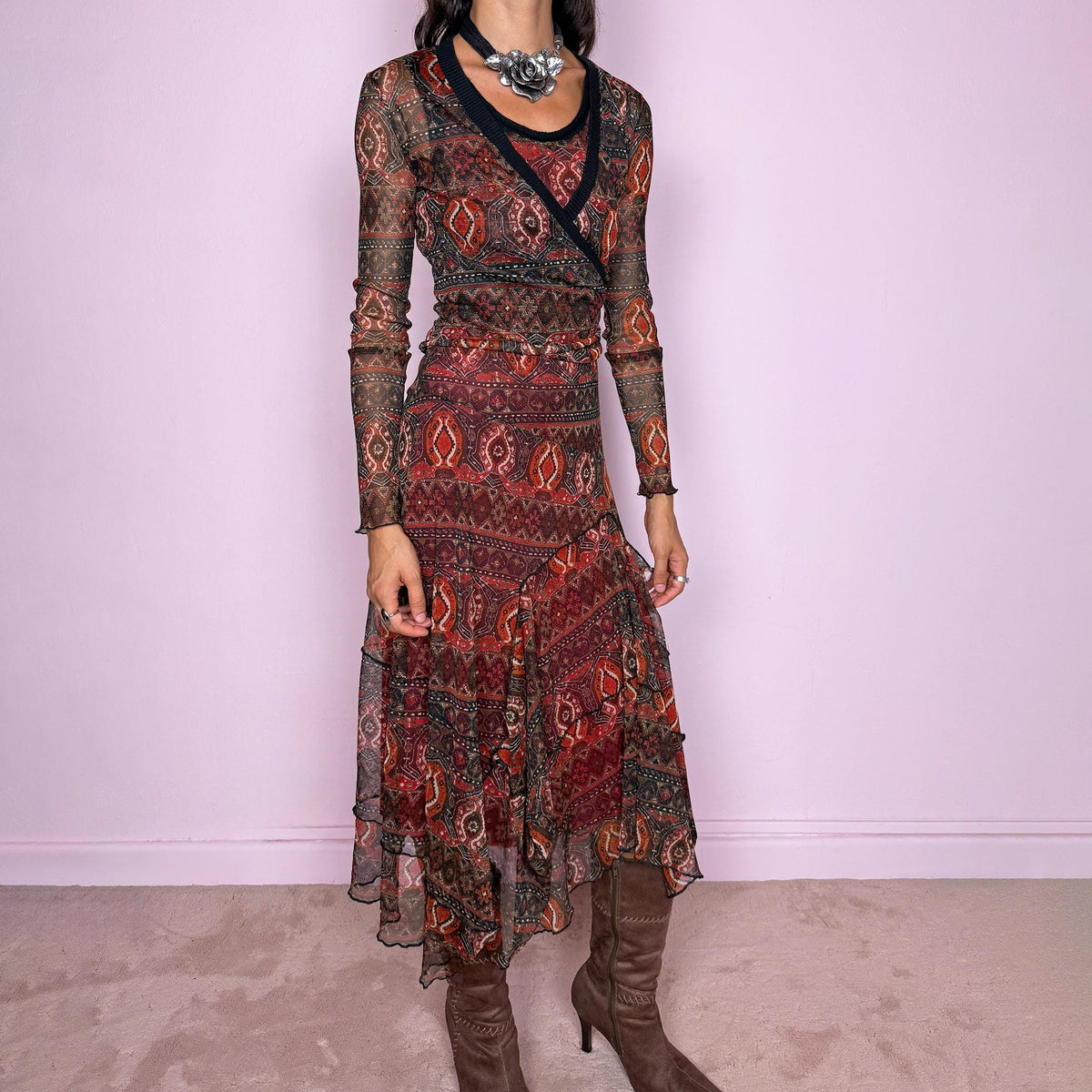 Vintage 2000s printed mesh two-piece dress set. The set includes a fitted sleeveless midi dress with a red lining and asymmetric layered hem, paired with a long-sleeve sheer mesh wrap top with tie fastening and contrasting black trim. Finished in an earthy red, burgundy, brown, and orange graphic print throughout. Perfect for layered bohemian styling. From a French brand, made in France from stretchy 100% polyester. Great vintage condition.