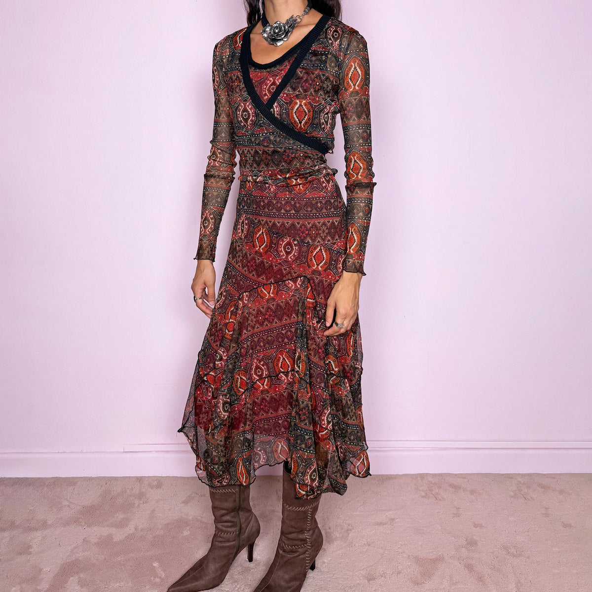 Vintage 2000s printed mesh two-piece dress set. The set includes a fitted sleeveless midi dress with a red lining and asymmetric layered hem, paired with a long-sleeve sheer mesh wrap top with tie fastening and contrasting black trim. Finished in an earthy red, burgundy, brown, and orange graphic print throughout. Perfect for layered bohemian styling. From a French brand, made in France from stretchy 100% polyester. Great vintage condition.