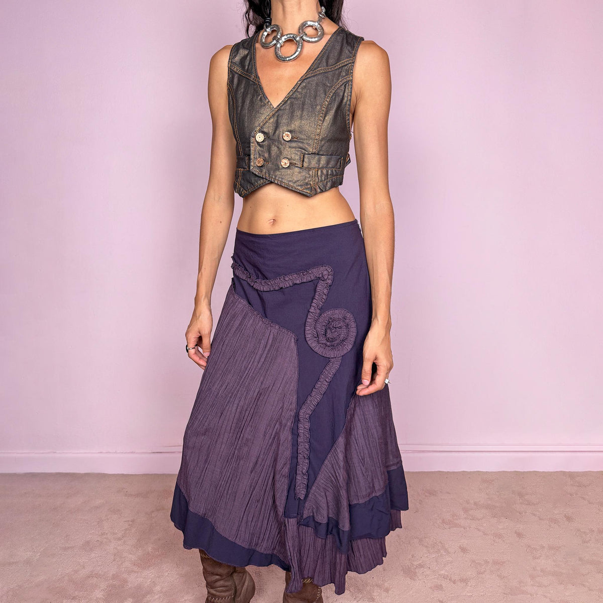 Vintage 2000s dark purple asymmetric midi skirt from a French brand, made in France. Features an irregular layered silhouette with contrasting pleated panels, curved seam construction, sculptural ruffled appliqué detailing, and a layered hem. Finished with a side zip closure. Can be worn high-waisted for size L or lower on the waist for sizes M–S.