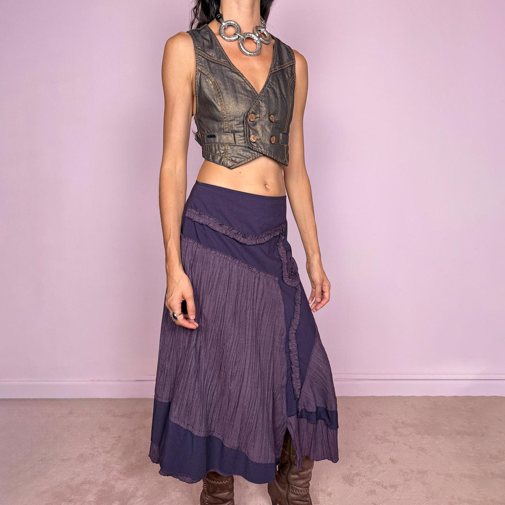Vintage 2000s dark purple asymmetric midi skirt from a French brand, made in France. Features an irregular layered silhouette with contrasting pleated panels, curved seam construction, sculptural ruffled appliqué detailing, and a layered hem. Finished with a side zip closure. Can be worn high-waisted for size L or lower on the waist for sizes M–S.