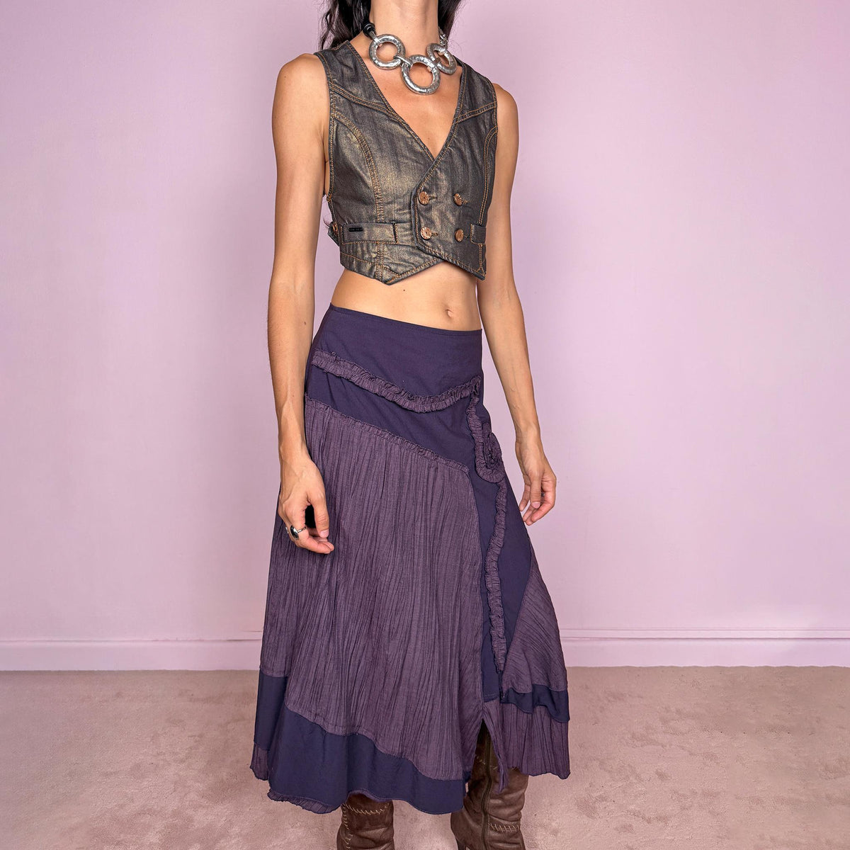 Vintage 2000s dark purple asymmetric midi skirt from a French brand, made in France. Features an irregular layered silhouette with contrasting pleated panels, curved seam construction, sculptural ruffled appliqué detailing, and a layered hem. Finished with a side zip closure. Can be worn high-waisted for size L or lower on the waist for sizes M–S.