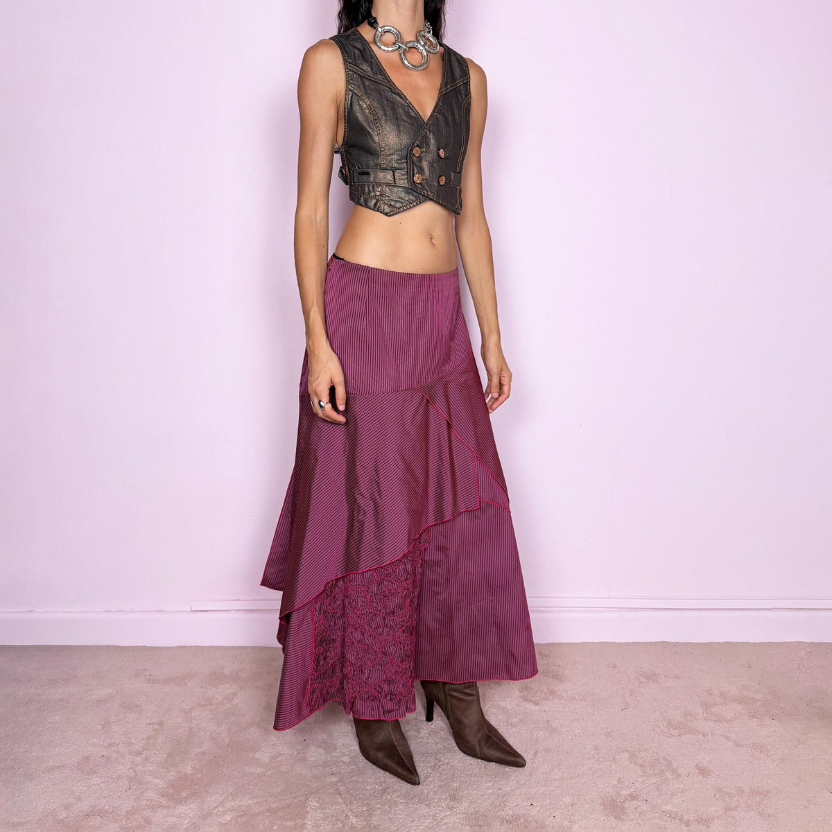 Vintage 2000s burgundy asymmetric maxi skirt featuring a side zip closure and an irregular layered construction combining fine pinstripe panels with ruched and gathered textured sections. Can be worn high-waisted for size L or lower on the waist for sizes M–S. From a French brand, made from 100% non-stretch polyester. Excellent vintage condition.