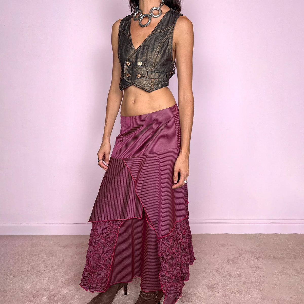 Vintage 2000s burgundy asymmetric maxi skirt featuring a side zip closure and an irregular layered construction combining fine pinstripe panels with ruched and gathered textured sections. Can be worn high-waisted for size L or lower on the waist for sizes M–S. From a French brand, made from 100% non-stretch polyester. Excellent vintage condition.