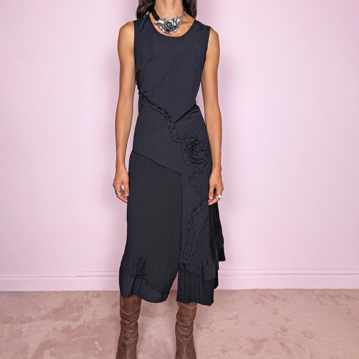 Vintage 2000s black asymmetric midi dress featuring a sleeveless silhouette with sculptural panel construction, mixed tonal textures, and ruffled trim creating an organic, deconstructed effect across the body. Finished with an irregular asymmetric hem and back zip closure. No stretch. For dark avant-garde looks. Made in France by a French brand. Main fabric: 61% viscose and 39% polyester. Other fabric: 54% cotton and 46% polyamide. Excellent vintage condition.