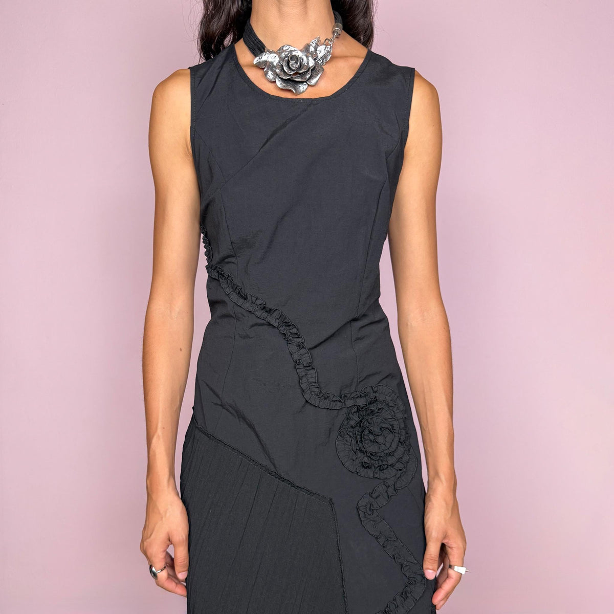 Vintage 2000s black asymmetric midi dress featuring a sleeveless silhouette with sculptural panel construction, mixed tonal textures, and ruffled trim creating an organic, deconstructed effect across the body. Finished with an irregular asymmetric hem and back zip closure. No stretch. For dark avant-garde looks. Made in France by a French brand. Main fabric: 61% viscose and 39% polyester. Other fabric: 54% cotton and 46% polyamide. Excellent vintage condition.