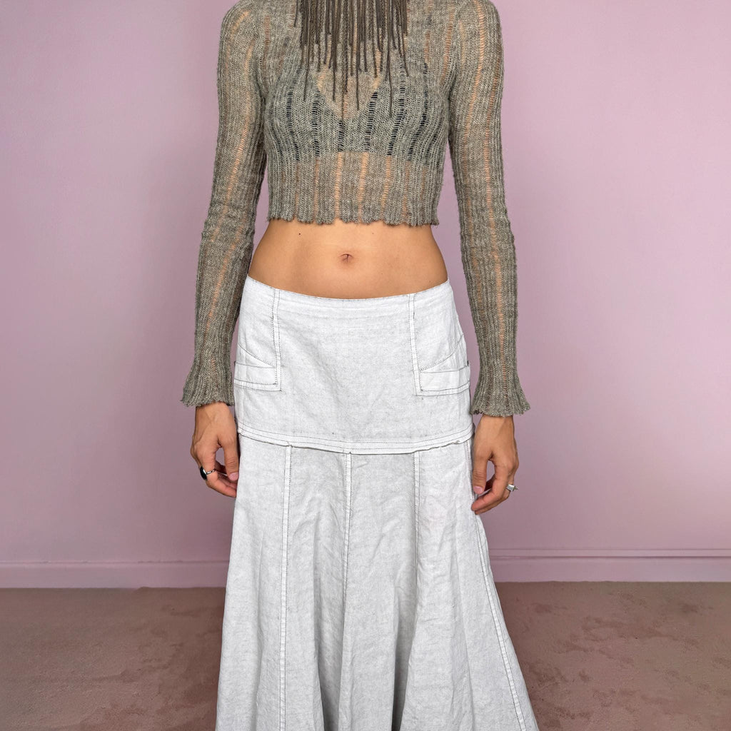 Vintage 2000s greyish-white maxi skirt by Belgian label Sarah Pacini, made in Italy from a non-stretch ramie blend. Features a fitted upper section, contrast topstitching, a back zip, a paneled flared silhouette, and an irregular handkerchief hem. Softly distressed, washed finish with a painted effect. Can be worn mid-rise for size S or lower on the waist for size XS. Excellent vintage condition.