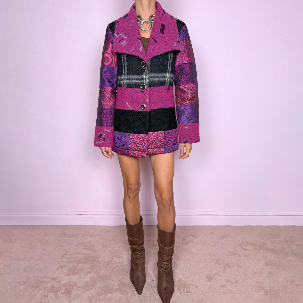 Vintage 2000s colorful wool-blend jacket by Italian label Save the Queen, made in Italy from 60% wool and 40% polyester. Features a fitted, tailored silhouette with an oversized magenta collar, statement button-front closure, and a bold patchwork-inspired mix of black, fuchsia, and purple panels with abstract, animal, and graphic motifs. Perfect for playful avant-garde maximalist styling, statement winter looks, and colorful outfits. Excellent vintage condition.