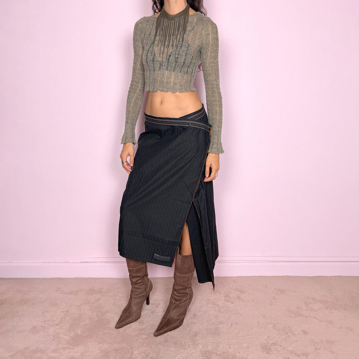 Vintage 2000s black midi skirt by French label Cop Copine, made from 100% cotton with no stretch. Features an asymmetric wrap-style construction, subtle vertical stripe texture, snap-button fastening at the waist, and a dramatic side slit with contrast topstitching. Finished with layered panel detailing for a deconstructed, utilitarian, dark avant-garde look. Can be worn mid-rise for size M or lower on the waist for size S. Excellent vintage condition.