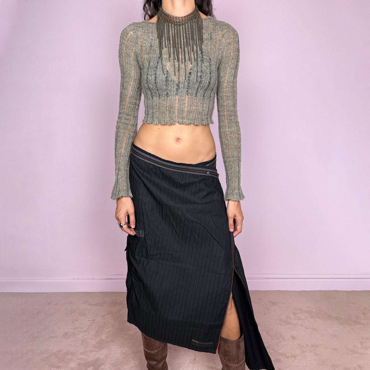 Vintage 2000s black midi skirt by French label Cop Copine, made from 100% cotton with no stretch. Features an asymmetric wrap-style construction, subtle vertical stripe texture, snap-button fastening at the waist, and a dramatic side slit with contrast topstitching. Finished with layered panel detailing for a deconstructed, utilitarian, dark avant-garde look. Can be worn mid-rise for size M or lower on the waist for size S. Excellent vintage condition.