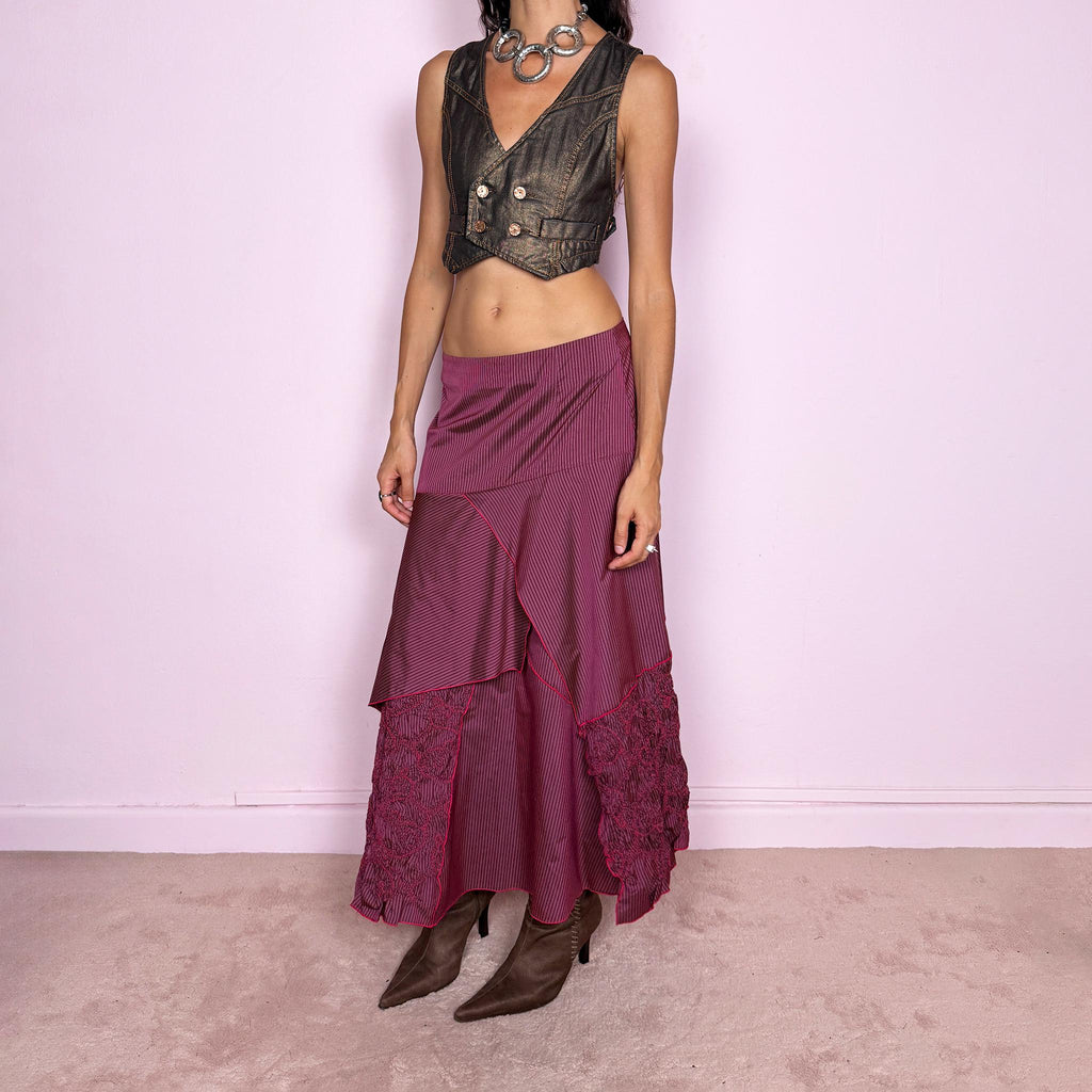 Vintage 2000s burgundy asymmetric maxi skirt featuring a side zip closure and an irregular layered construction combining fine pinstripe panels with ruched and gathered textured sections. Can be worn high-waisted for size L or lower on the waist for sizes M–S. From a French brand, made from 100% non-stretch polyester. Excellent vintage condition.