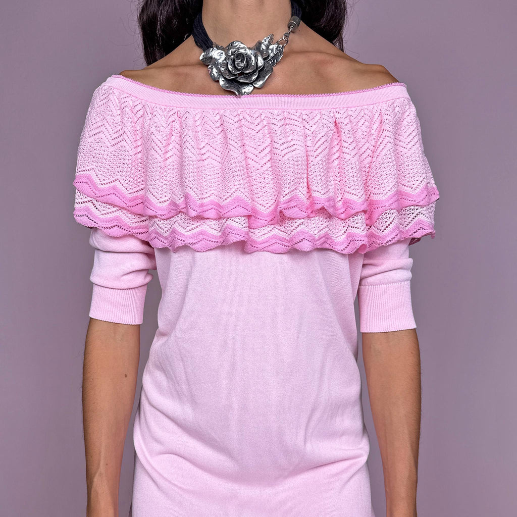 Vintage 2000s light pink knit mini dress by Italian designer label Blumarine, made in Italy from a stretchy 67% viscose and 33% cotton blend. Features a soft straight silhouette with an off-the-shoulder neckline, layered pointelle-knit ruffle detailing across the shoulders, elbow-length sleeves and ribbed trim at the hem and cuffs. Excellent vintage condition.