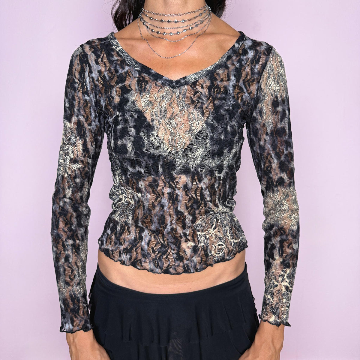 Vintage 2000s long-sleeve lace top by Italian designer label Roberto Cavalli, made in Italy from 100% polyamide. Features a semi-sheer stretch lace construction with an animal-inspired print in black, gray, cream and warm neutral tones, mixed with contrasting floral lace motifs. Designed with a fitted body-skimming silhouette, V neckline and long sleeves. The garment features both Roberto Cavalli and Just Cavalli labels. Excellent vintage condition.