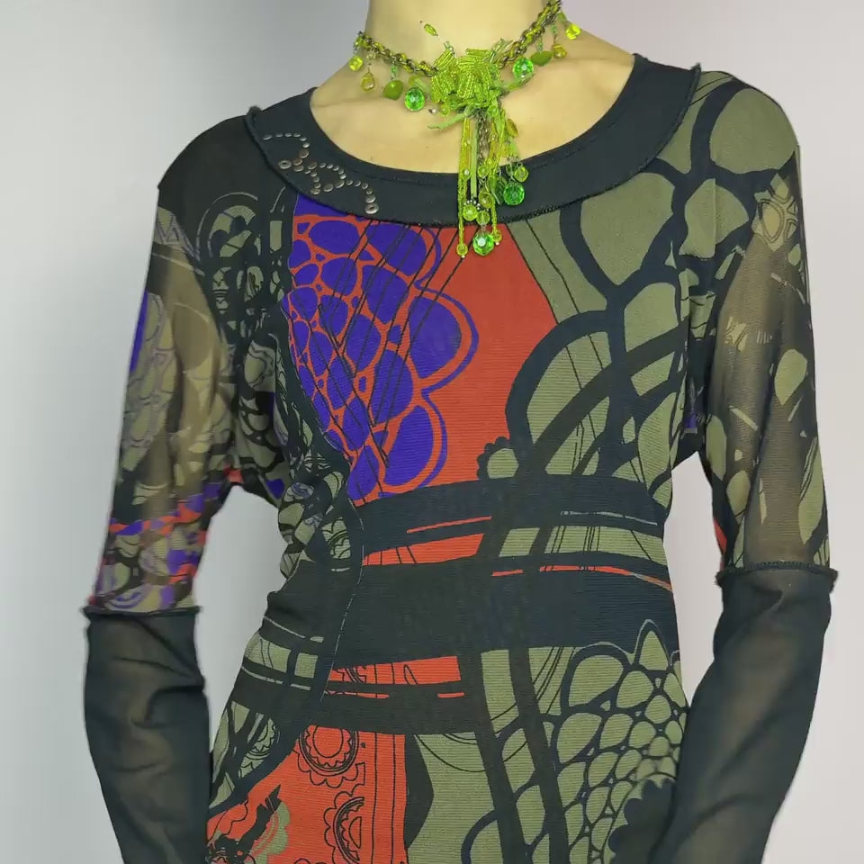 The Y2K Abstract Printed Mesh Top is a vintage 2000s sheer long-sleeve top featuring a bold abstract print in earthy tones with pops of red and blue. Designed with contrast black mesh sleeves, this artistic piece is perfect for edgy streetwear, cyberpunk, or grunge-inspired outfits. Ideal for layering or wearing solo for a statement look.